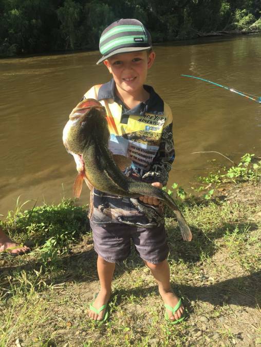 Caylin Swadling holds up his catch at a previous fishing day in Moree. 
