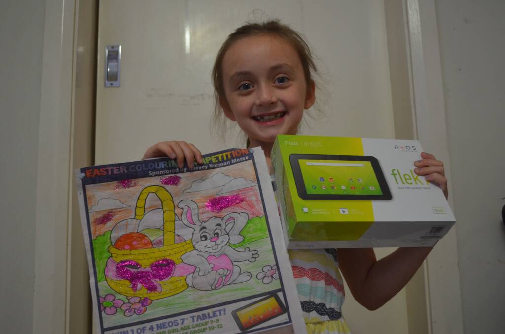 Adding glitter: Eight-year-old Amelia Powlton picked up her new tablet just before Easter, thanks to Harvey Norman Moree.