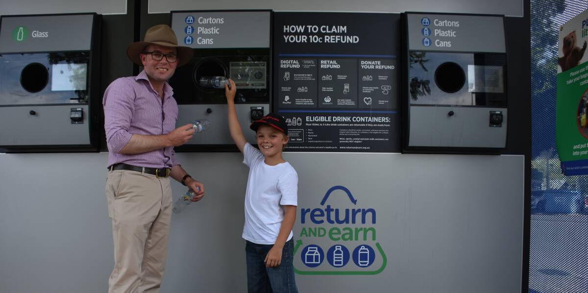 Top effort: Member for Northern Tablelands Adam Marshall and nine-year-old Charlie Crouch use the return and earn machine in Moree.