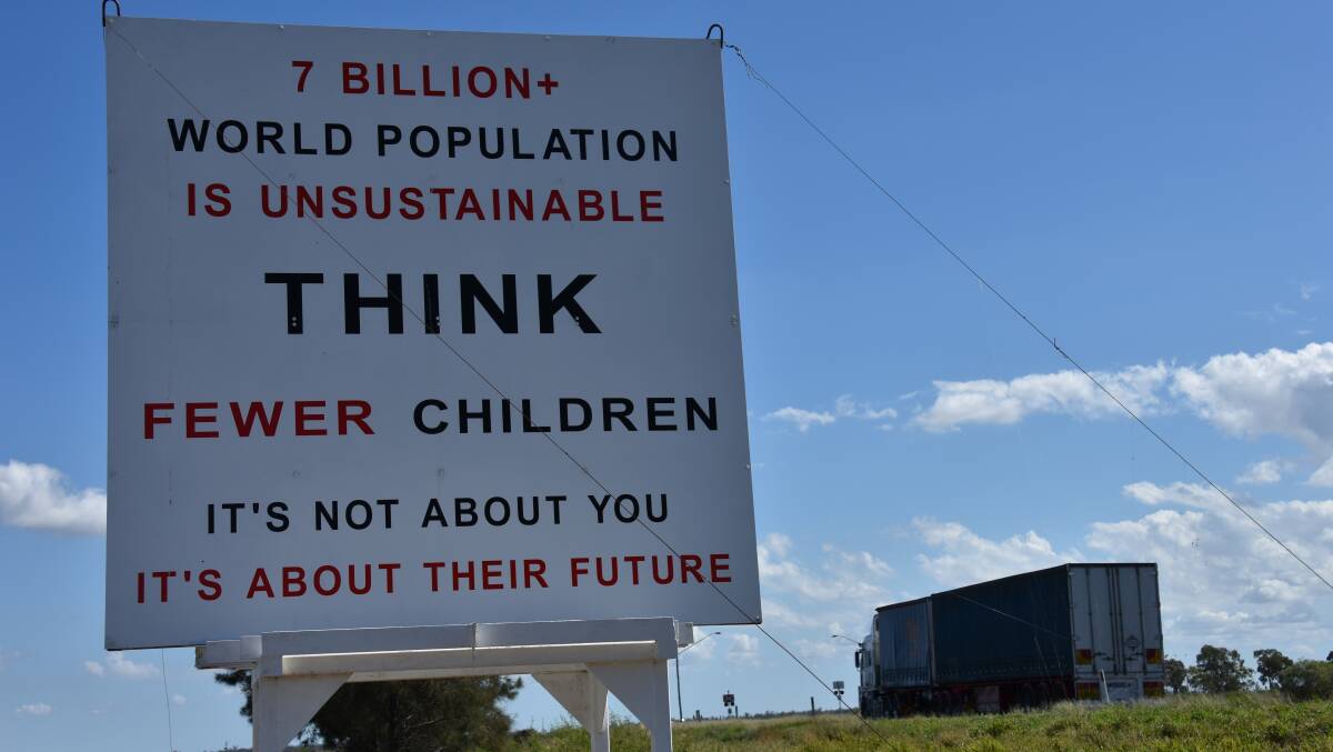 WARNING: Mr Schneebeli painted the new sign last December, suggesting overpopulation fueled the growth of CSG mines to keep up with international demand.