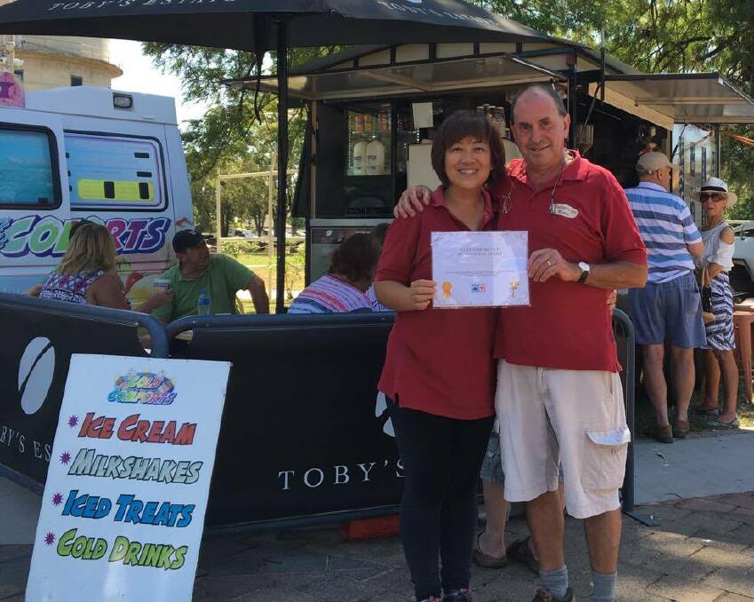 Congratulations: Cindy and Bill Poulos were awarded their certificate at the monthly markets on Sunday. Photo: Contributed by Thumbs Up Thumbs Down admin.