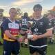 New holders: Moree captain Duncan Woods (right) receives the Kookaburra Challenge Cup from CN/NE Referees Association representative Jeremy Matthews.