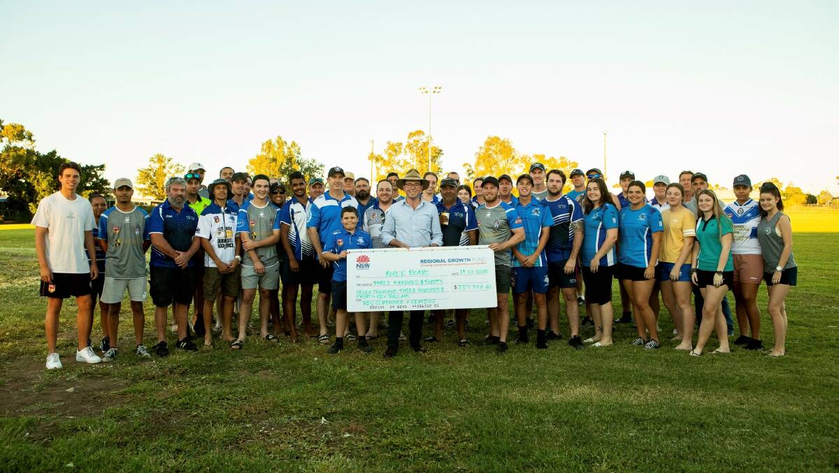 Northern tablelands MP Adam Marshall, centre, presents a large funding cheque to the Moree Boars Rugby League Football Club for a new clubhouse and grandstand at Boughton Oval.