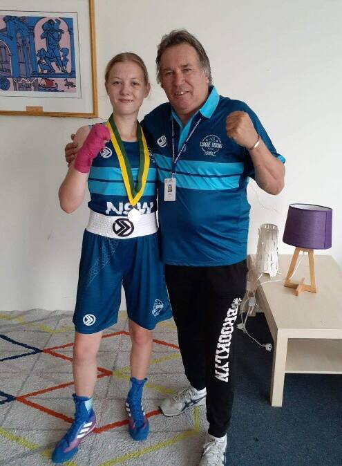 AUSSIE CHAMP: Katie Defraine celebrates her gold medal victory with coach Danny Cheetham. Photo: supplied.
