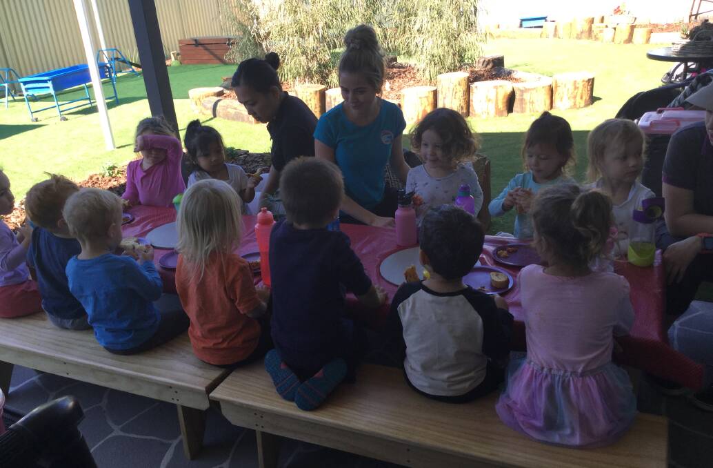 Goodstart children and staff enjoying the new tables donated by Moree Men's Shed. Photo: supplied.