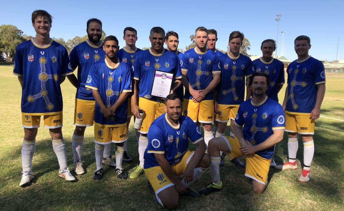OUTSTANDING CONTRIBUTION: Darrel Smith (centre) with his Community Coach of the Month award and his Moree Services FC teammates. Photo: supplied.