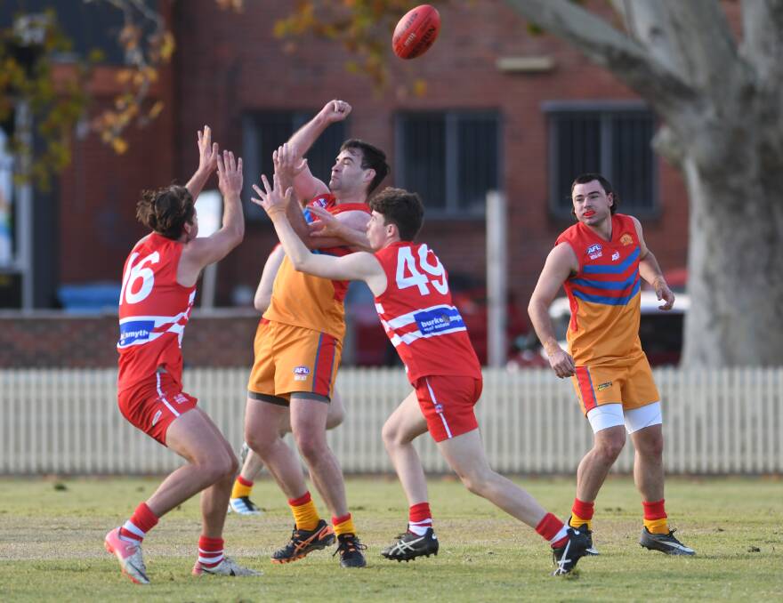 STILL IMPROVING: Daniel Kearney punches the ball ahead in the Suns match against the Swans on Saturday. Photo: Gareth Gardner