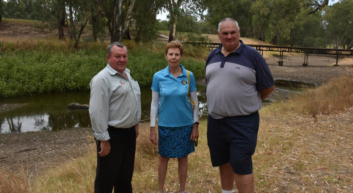 NO HELP: Moree Golf Club manager Scot McLeod, member Cecilia Baker and president Brian Willett in front of the dry Mehi River running through the golf course