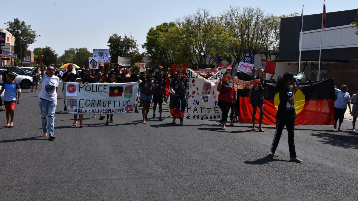Hundreds of people marched in front of the Moree Police Station to protest police treatment of the Aboriginal community