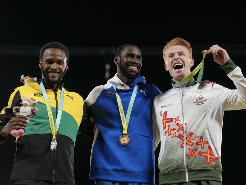 Medallists Jaheel Hyde, Kyron McMaster and Alastair Chalmers celebrate after the 400m hurdles. (AP PHOTO)