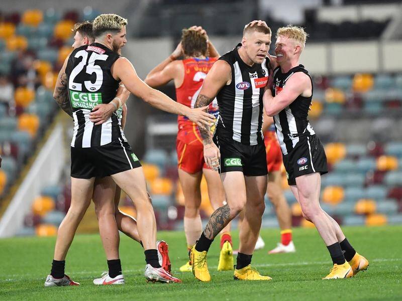 Collingwood's Jordan De Goey (2nd r) was the leading goal kicker on their AFL defeat of Gold Coast.