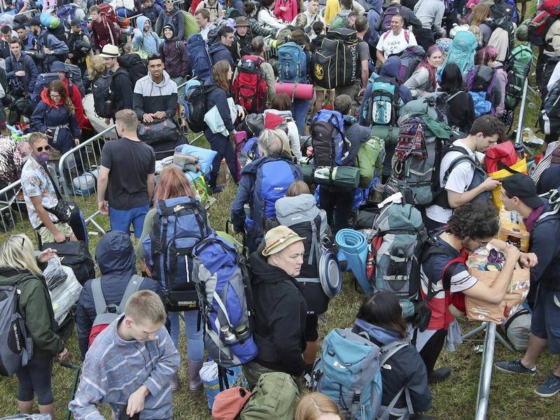 People queue for entry on the first day of the Glastonbury Festival in Somerset, England.