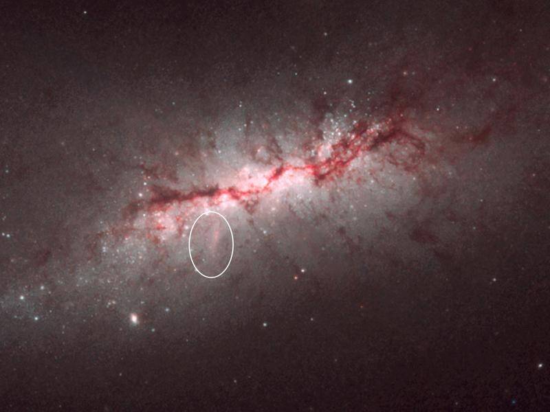 Spiral Galaxy NGC 4424 displays evidence of an earlier star-forming event 500 million years ago.