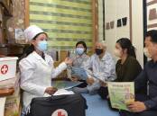 A doctor visits a family to raise awareness of COVID prevention measures in Pyongyang, North Korea.