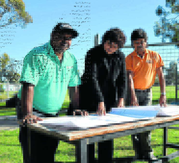 Senior leader of community engagement and connections Matthew Priestly, executive principal Murial Kelly and president of the Moree Aboriginal Education Consultative Group and chair of the Moree East Public School Reference Group Lloyd Munro peruse the plans for the $15 million major upgrade forecast for Moree East Public School. 