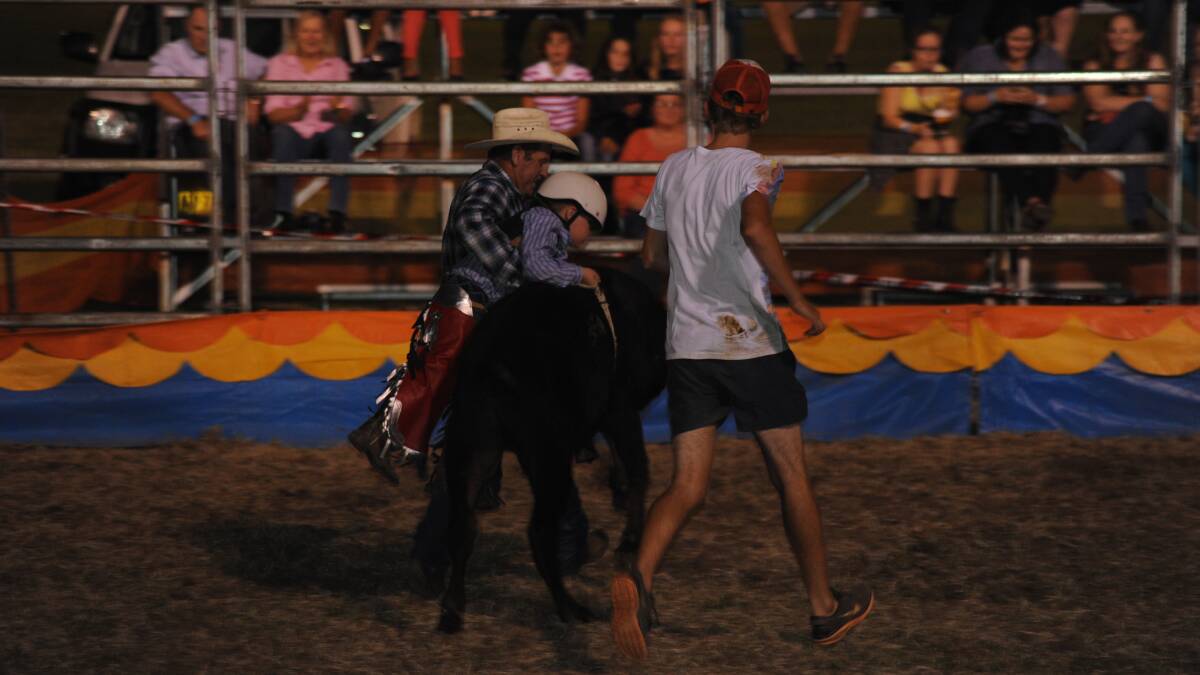 Jacob Williams gets some assistance in the poddy calf ride.