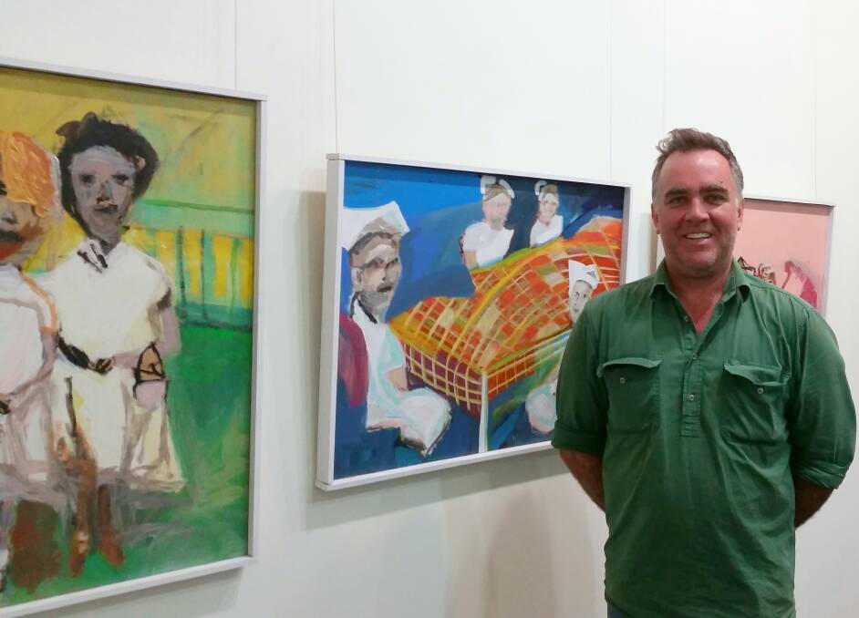 Nicholas Osmond in front of some of his paintings currently on display at Moree Plains Gallery.