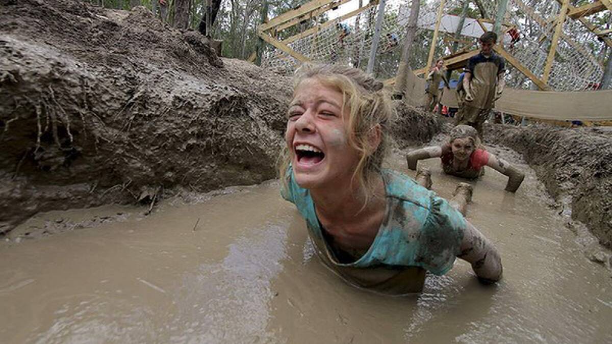 Meg Wilhelmi, 13, from Alice River, Townsville, QLD, goes through the mud obstacle course. Photo: Michelle Smith
