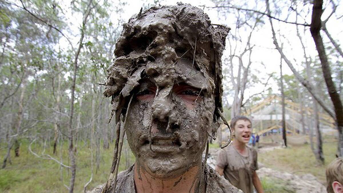 Christopher Kirkman, 14, from Manly-Lota, QLD, goes through the mud obstacle course. Photo: Michelle Smith