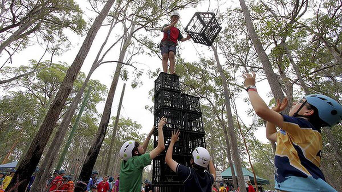 Jarrod Harrison, 13, from Frankston, Victoria, is helped by his fellow club members in the crate stacking challenge. Photo: Michelle Smith