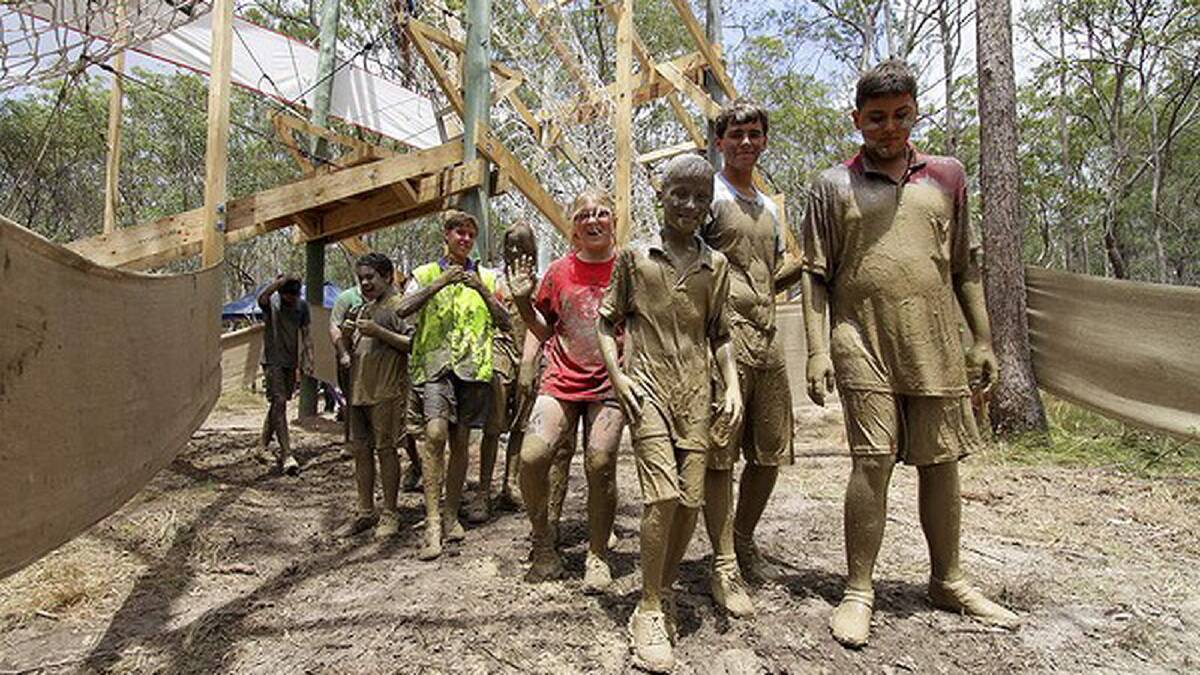 Scouts are covered in mud going through the mud obstacle course. Photo: Michelle Smith